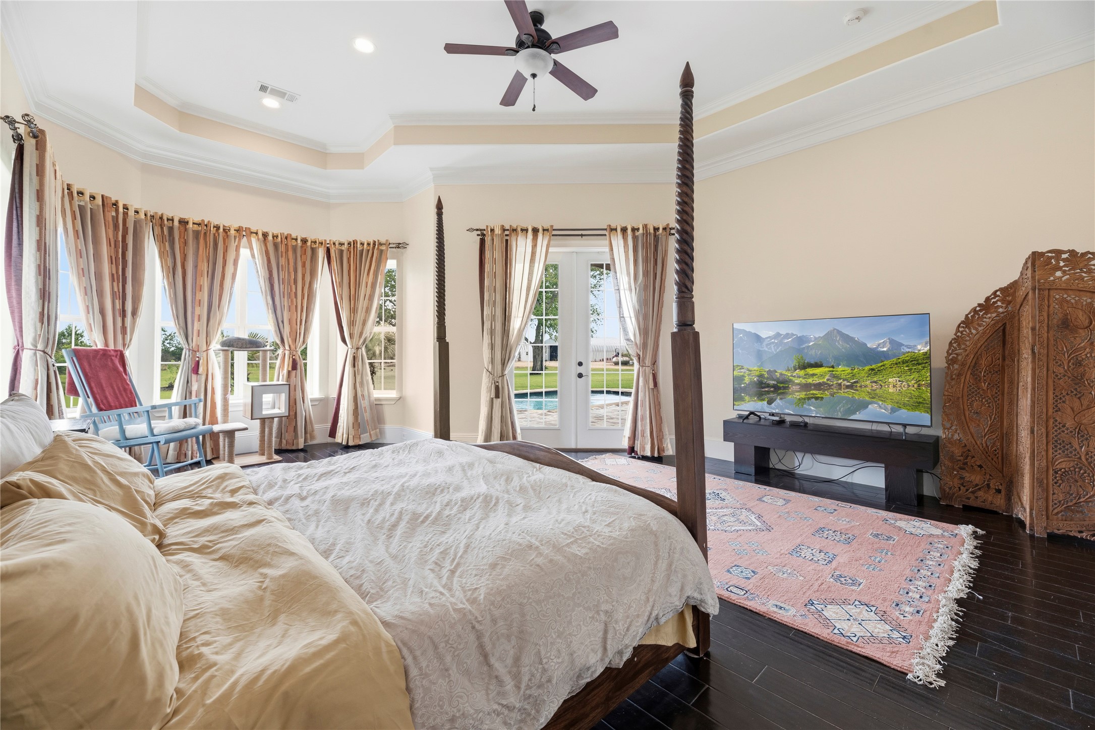 6306 Farm To Market 359 Fulshear, TX 77441 - Photo 17 of 44 This primary suite offers tray ceilings and a tranquil atmosphere with private French door access to the pool deck. One of the dual walk-in closets is constructed with Insulated Concrete Forms (ICF) to serve as a reinforced safe room.