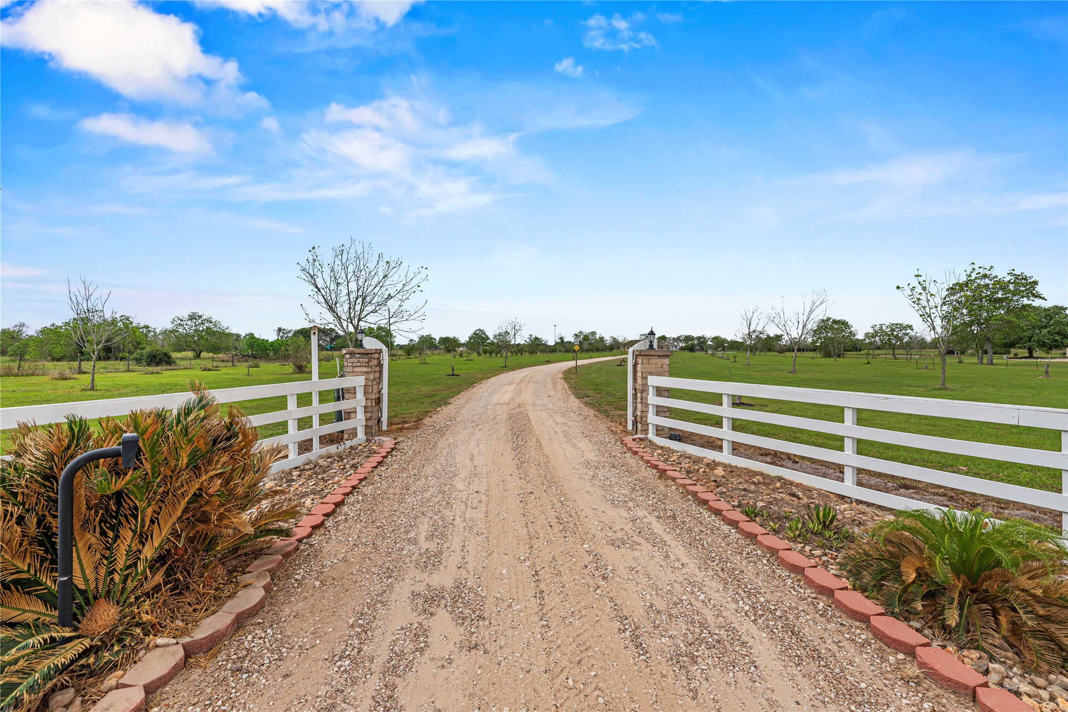 6306 Farm To Market 359 Fulshear, TX 77441 - Photo 2 of 44 A gated entry welcomes you into 12.6 private acres in the heart of Fulshear, setting the tone for a property designed for those who value beauty, performance, peaceful ranch living and exceptional privacy just minutes from town.
