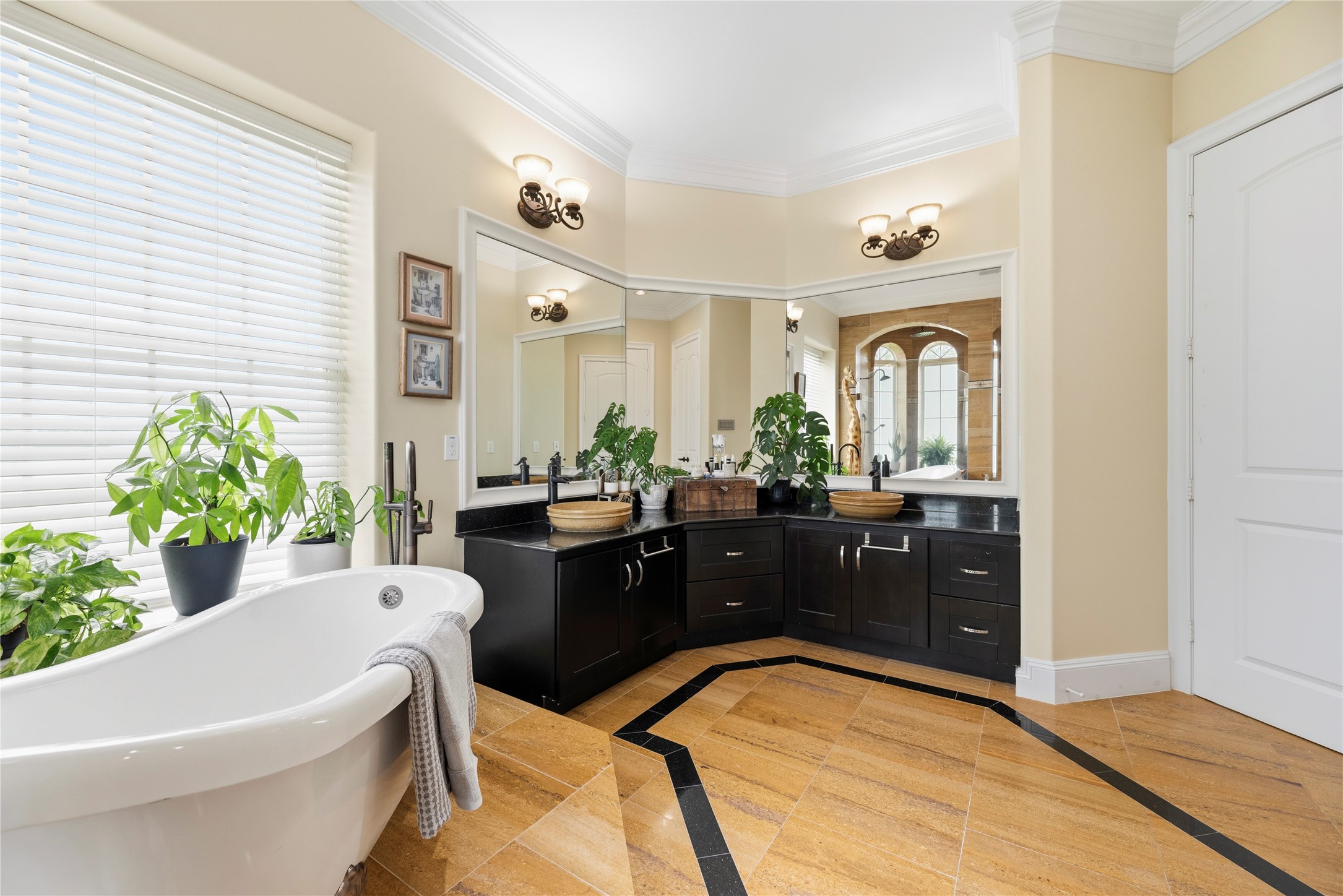 6306 Farm To Market 359 Fulshear, TX 77441 - Photo 21 of 44 Highlighting the custom double sinks and expansive mirrors, this masterfully designed bathroom offers seamless access to the private safe room.