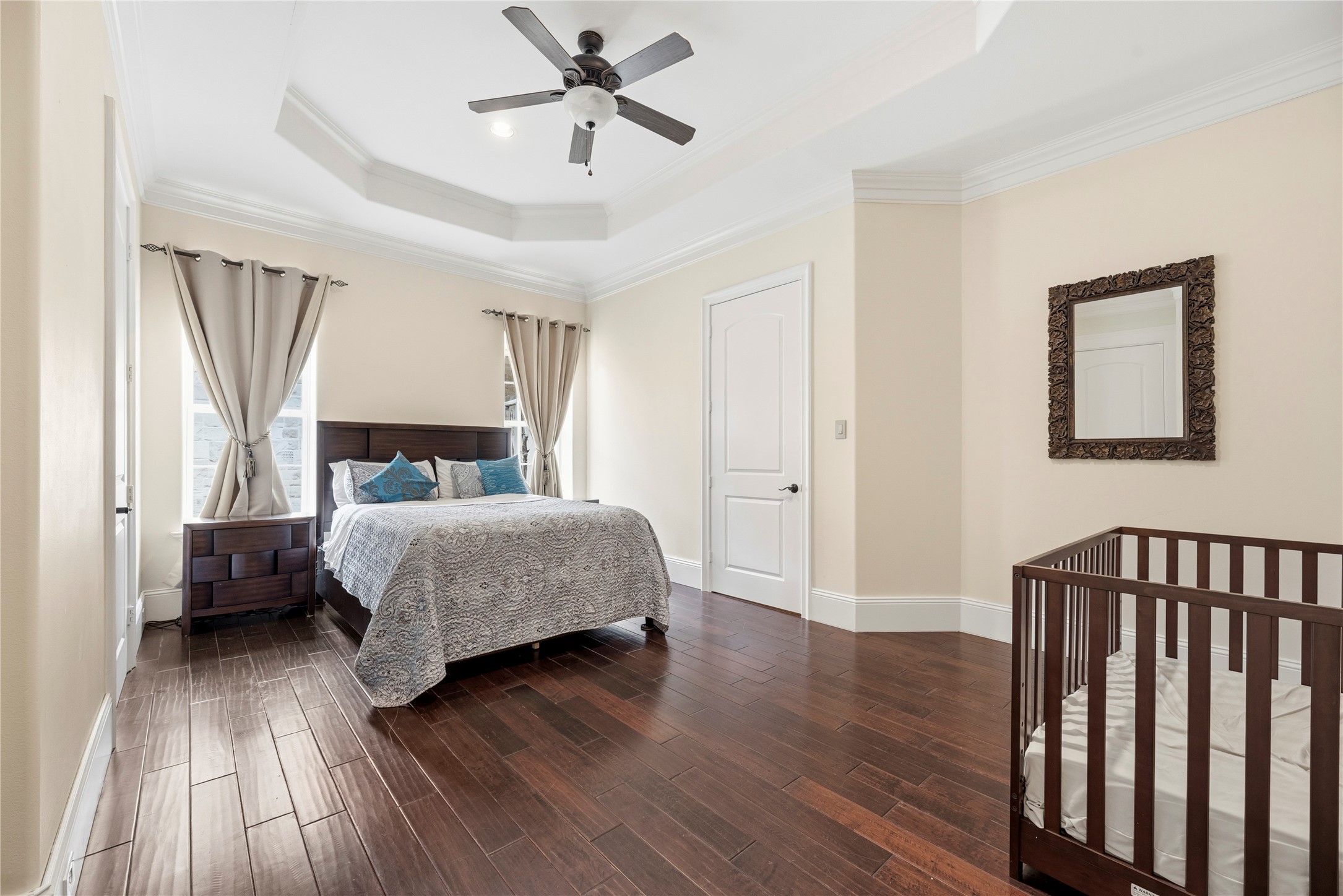6306 Farm To Market 359 Fulshear, TX 77441 - Photo 24 of 44 The third bedroom is detailed with custom tray ceilings, providing a quiet, light-filled atmosphere with views of the estate's sprawling acreage.