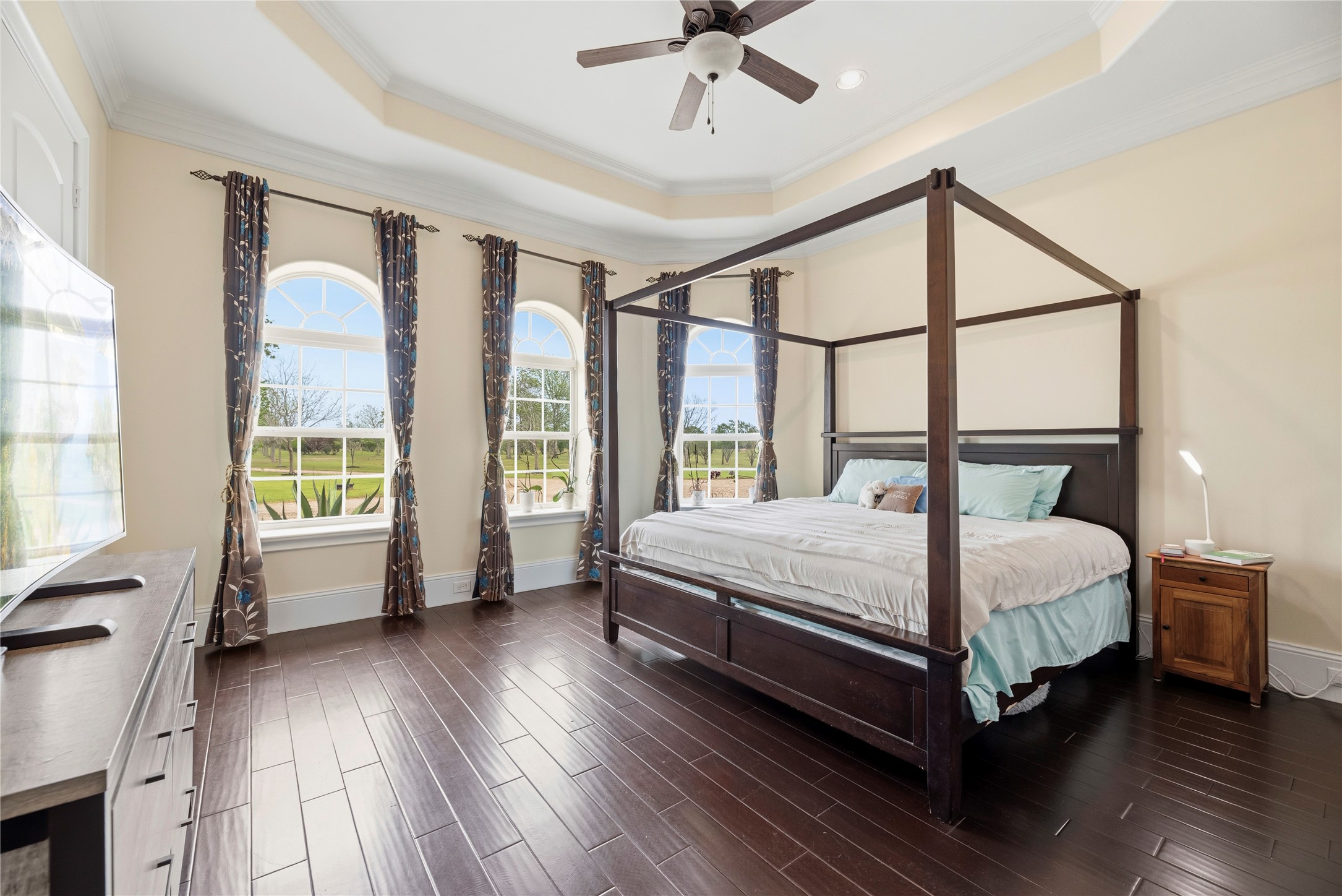 6306 Farm To Market 359 Fulshear, TX 77441 - Photo 25 of 44 Three large arched windows maximize natural light in this refined fourth bedroom, which offers a sophisticated vantage point over the landscape and the convenience of an en-suite bathroom.