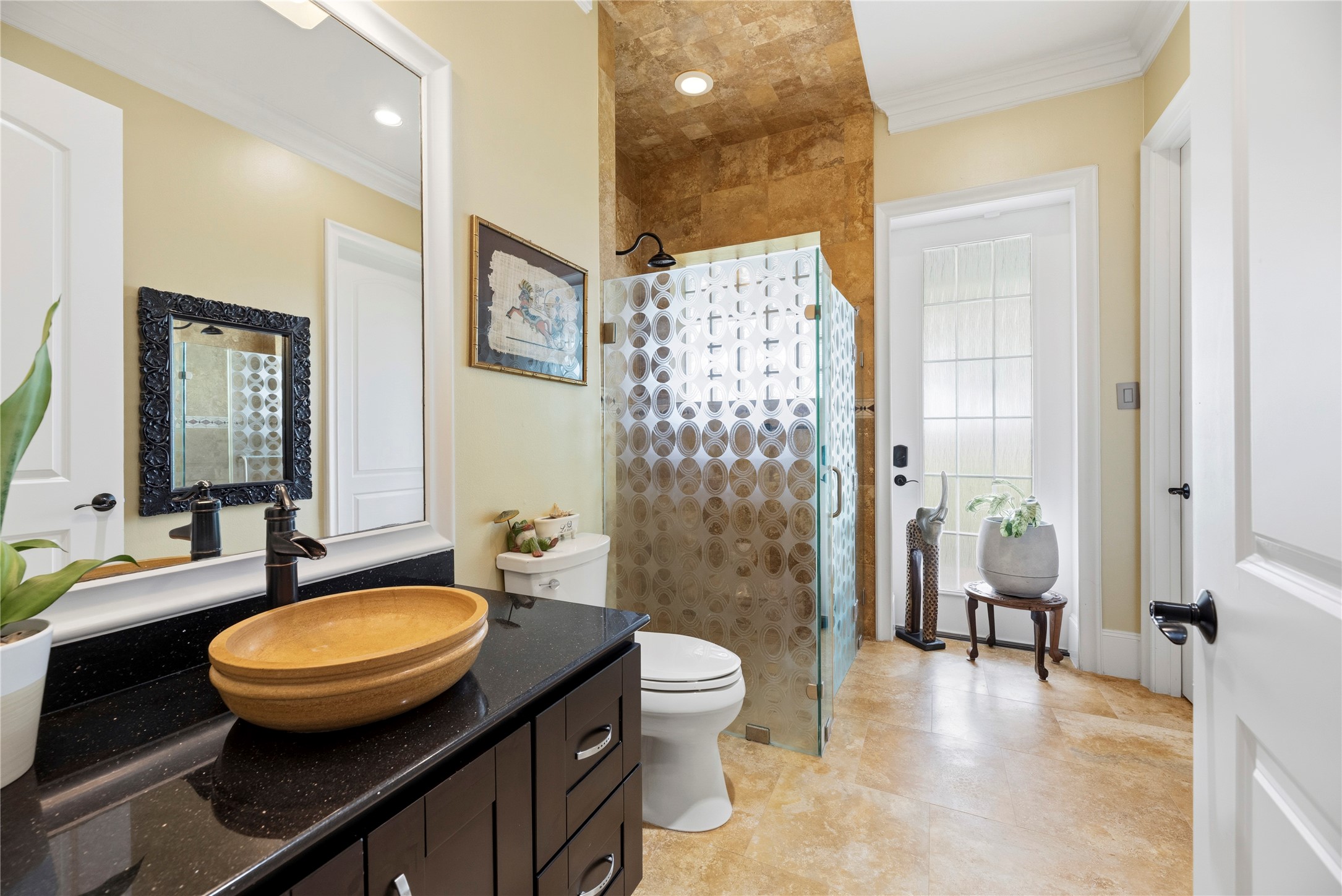 6306 Farm To Market 359 Fulshear, TX 77441 - Photo 27 of 44 This elegant secondary bath showcases a modern glass-enclosed shower accented by custom granite vanities. Adding a touch of convenience to luxury, the private door provides direct access to the pool area, making it the perfect transition for indoor-outdoor living.