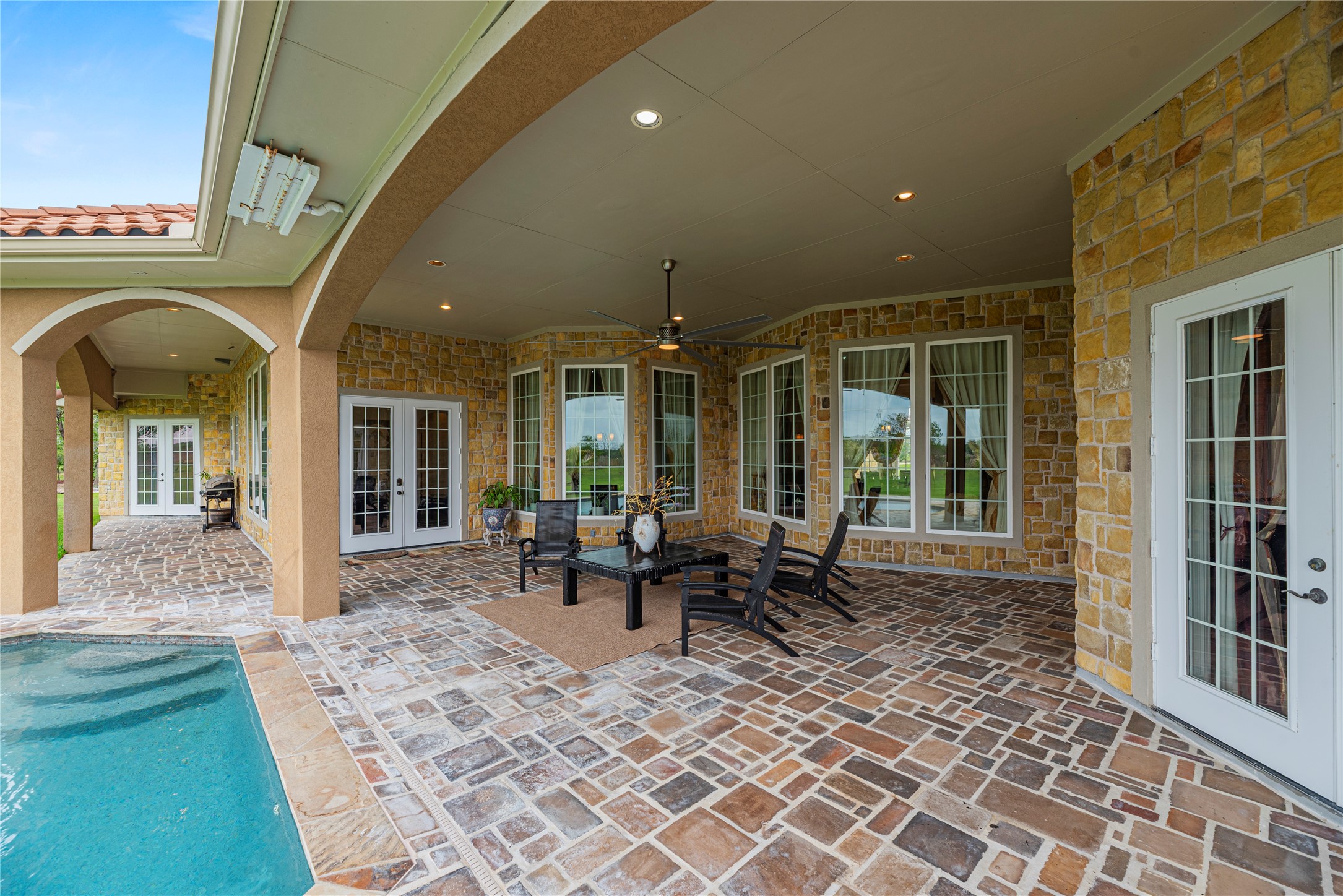 6306 Farm To Market 359 Fulshear, TX 77441 - Photo 31 of 44 This huge 900 sq. ft. covered patio features custom stone accents, a large cooling fan, and is fully wired for an integrated speaker system for world-class entertaining.