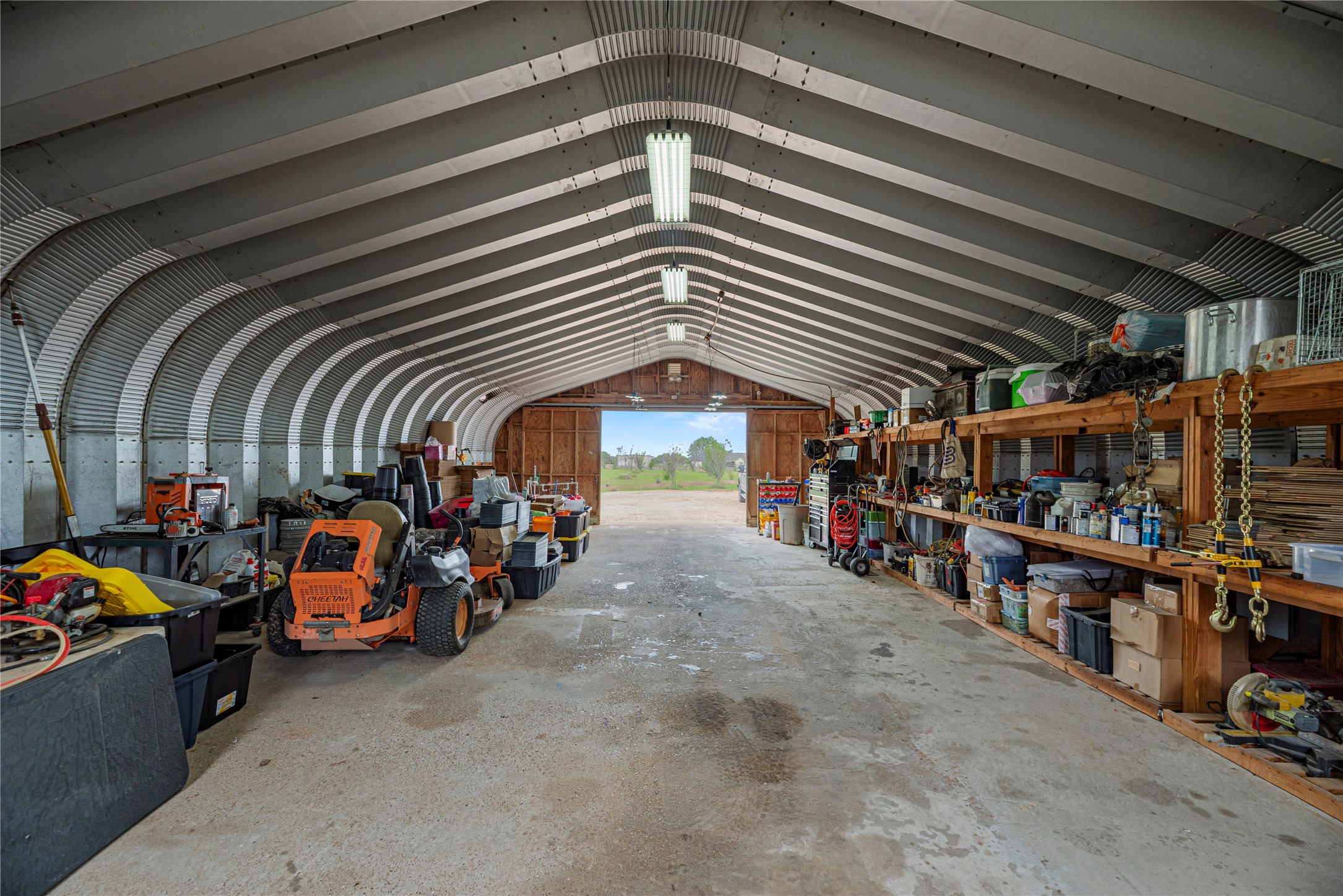 6306 Farm To Market 359 Fulshear, TX 77441 - Photo 37 of 44 The barn’s interior reveals a spacious, open layout with high clearance and Multiple disconnects, providing an ideal, customized environment for a significant workshop, extensive storage, or the pursuit of serious hobbies.