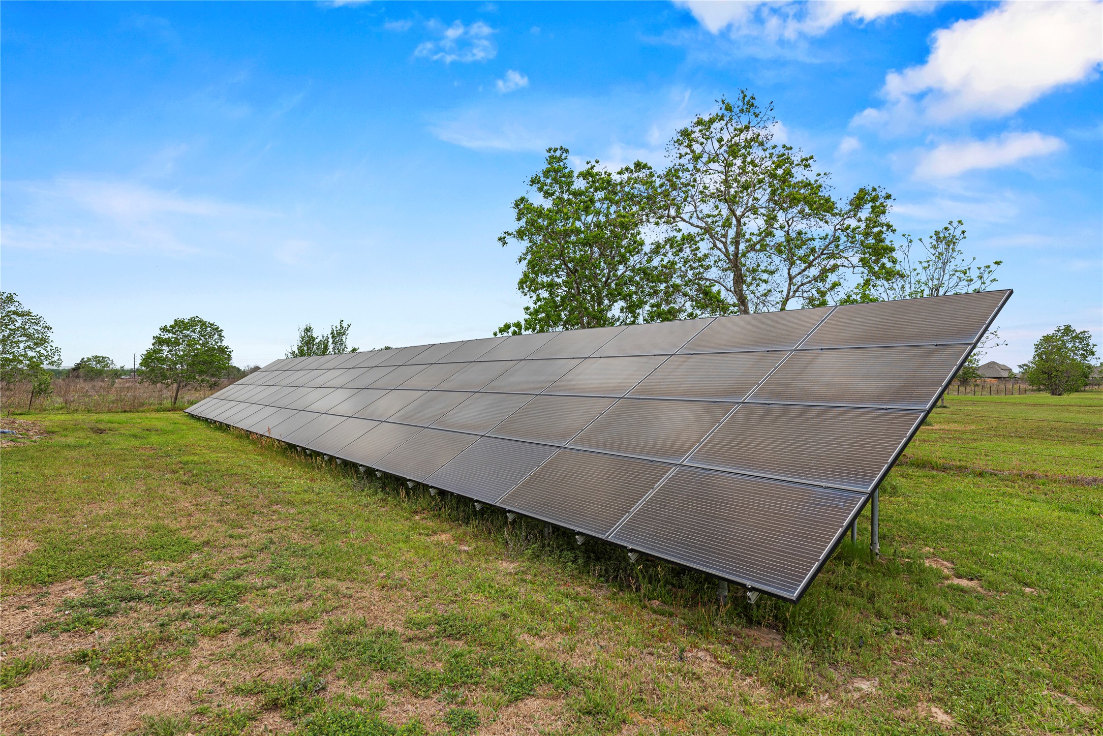 6306 Farm To Market 359 Fulshear, TX 77441 - Photo 4 of 44 A 19.2 kW ground-mounted solar array anchors the property’s energy independence, complementing a geothermal HVAC system and R-50 equivalent insulation.