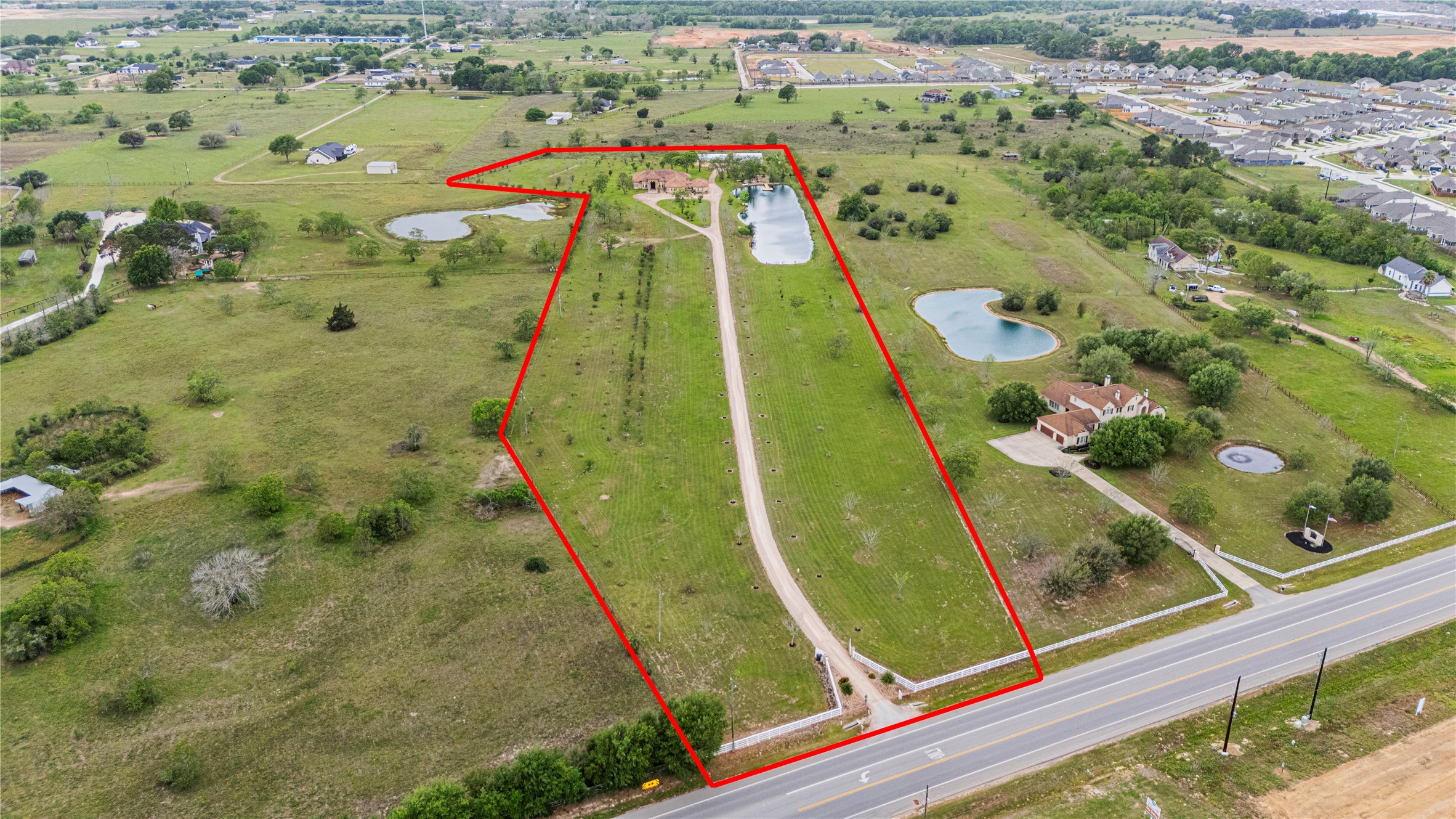 6306 Farm To Market 359 Fulshear, TX 77441 - Photo 42 of 44 This final aerial view showcases the property’s impressive 1,500-foot private driveway and its strategic, convenient access to FM 359, just minutes from top-rated Fulshear schools.