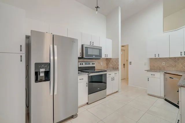 a view of an empty room with a fan