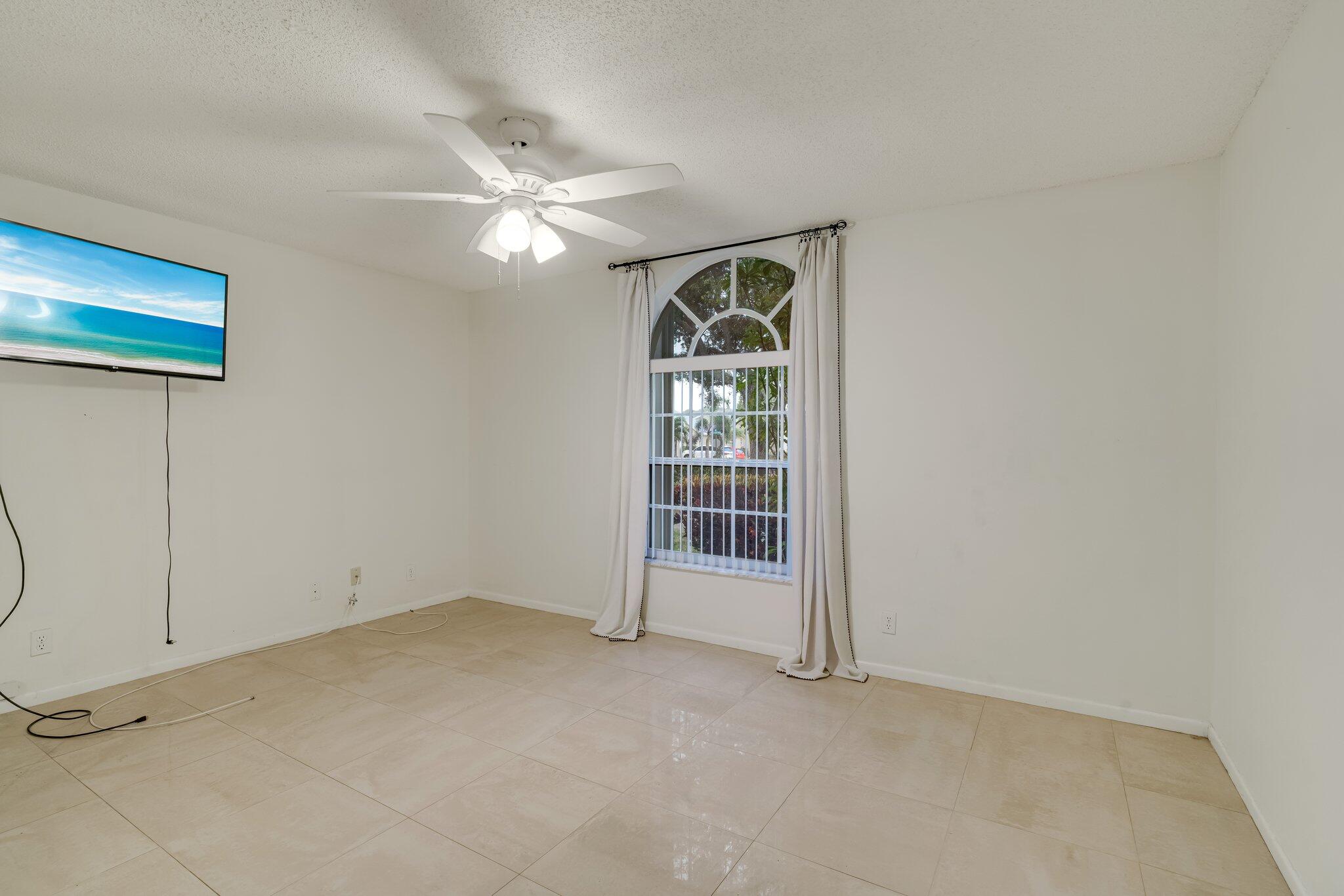 6209 Pond Tree Court Greenacres, FL 33463 - Photo 13 of 38 a view of an empty room with a window