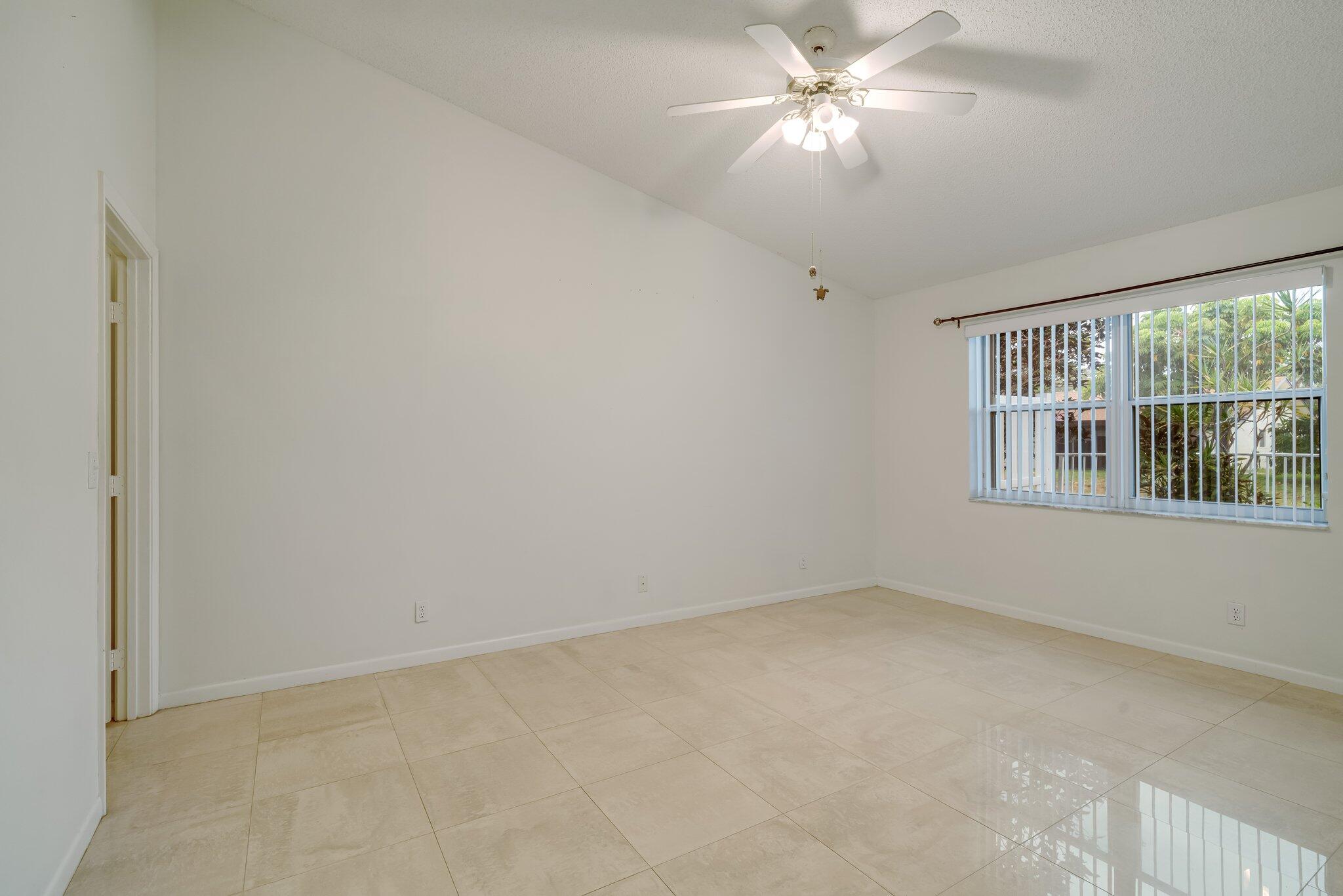 6209 Pond Tree Court Greenacres, FL 33463 - Photo 22 of 38 a view of an empty room with a window