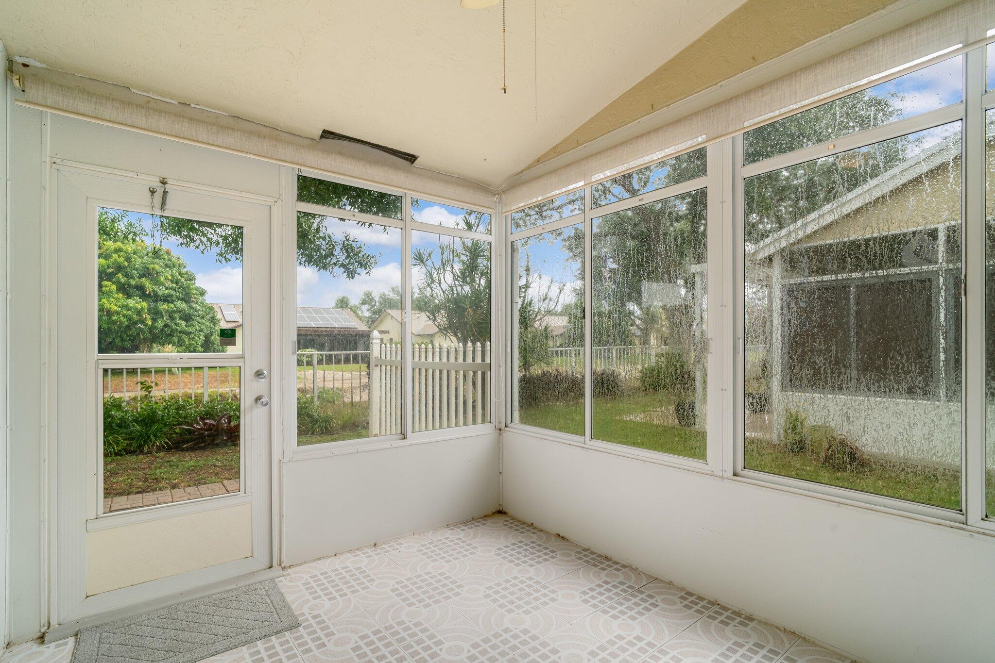 6209 Pond Tree Court Greenacres, FL 33463 - Photo 28 of 38 a view of a glass door and deck