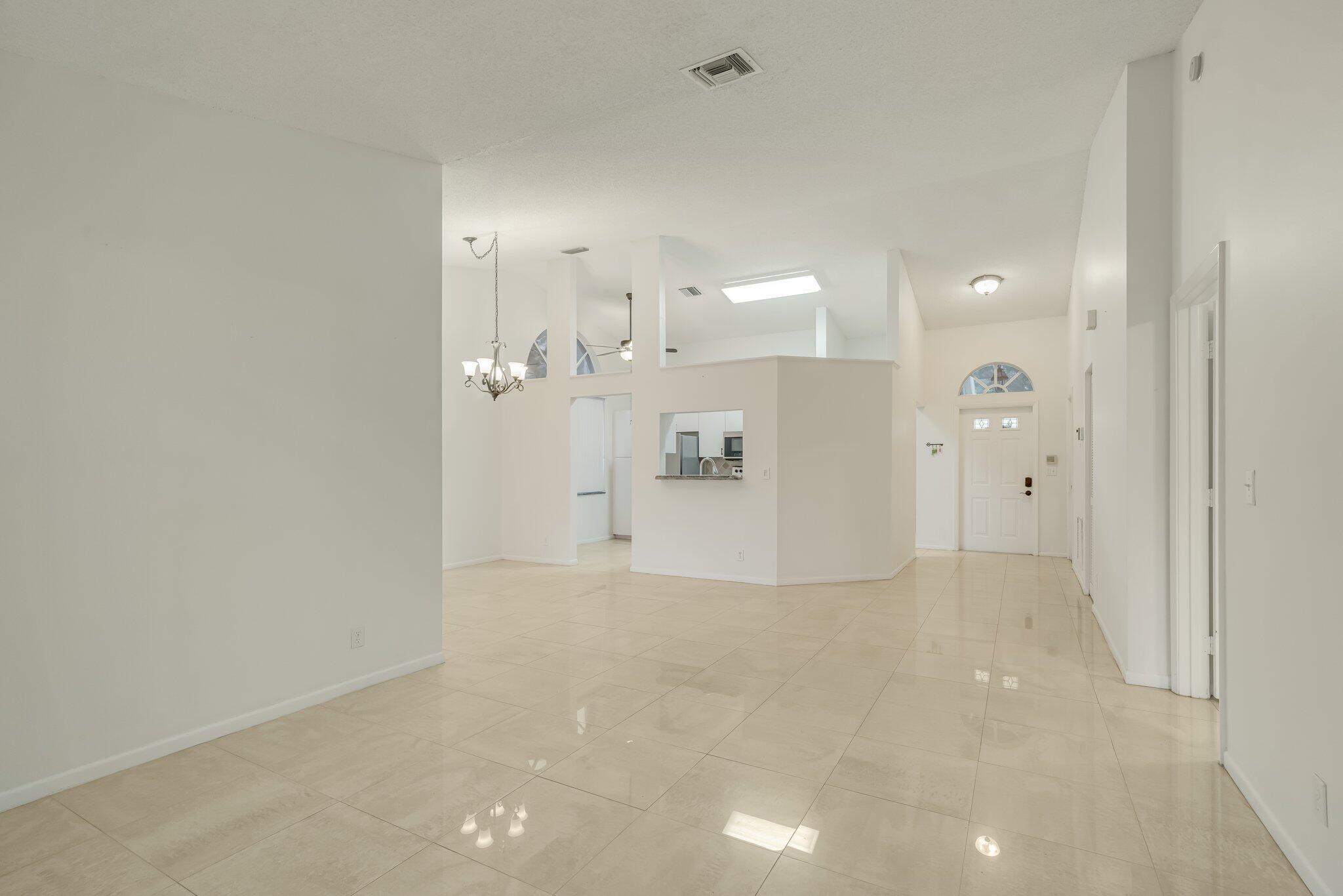 6209 Pond Tree Court Greenacres, FL 33463 - Photo 6 of 38 a view of a big room with closet and windows
