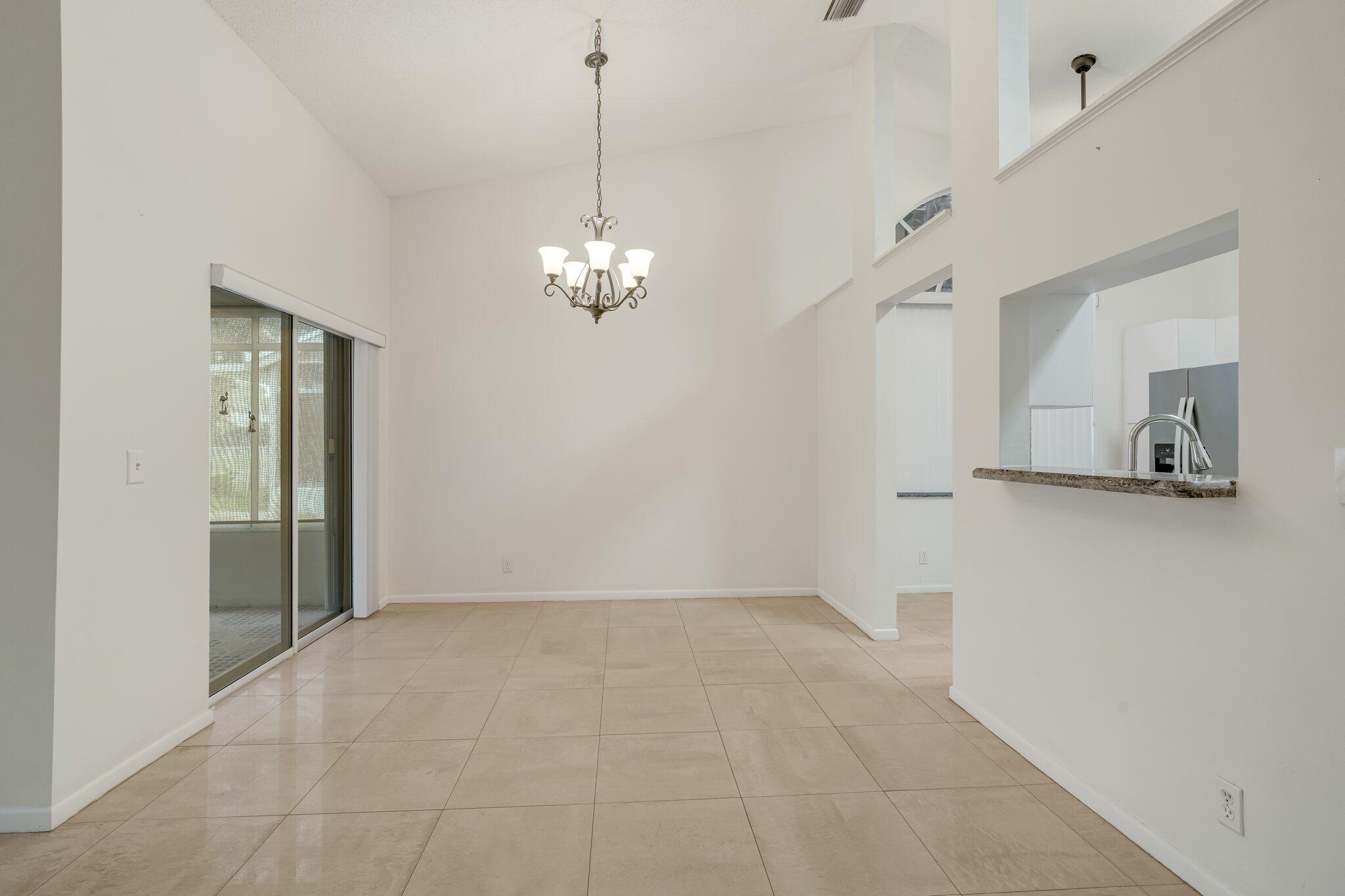 6209 Pond Tree Court Greenacres, FL 33463 - Photo 7 of 38 a view of a livingroom with a chandelier