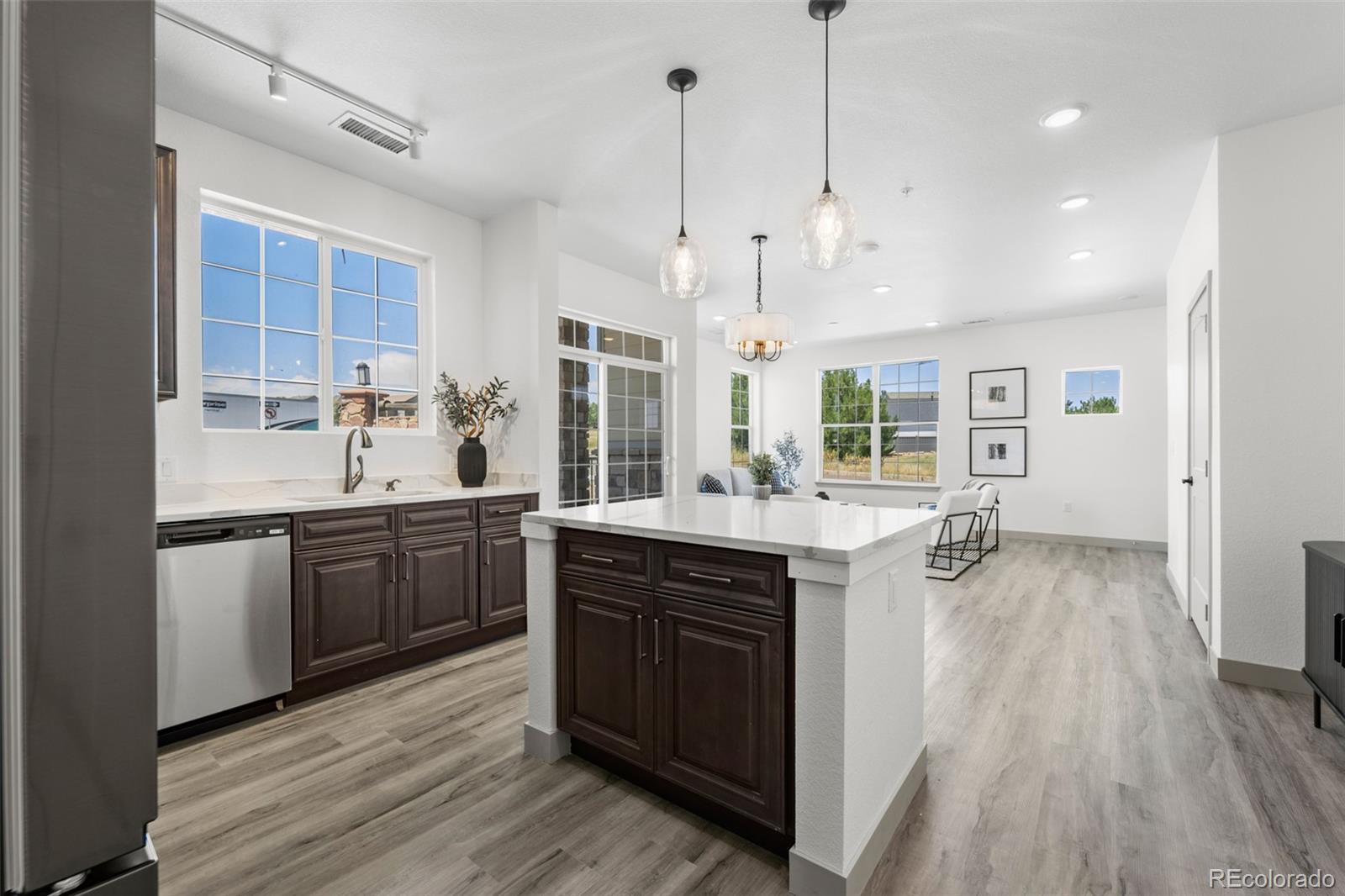 18633 Stroh Road, Unit 1102 Parker, CO 80134 - Photo 11 of 36 a kitchen with a sink stove and wooden cabinets