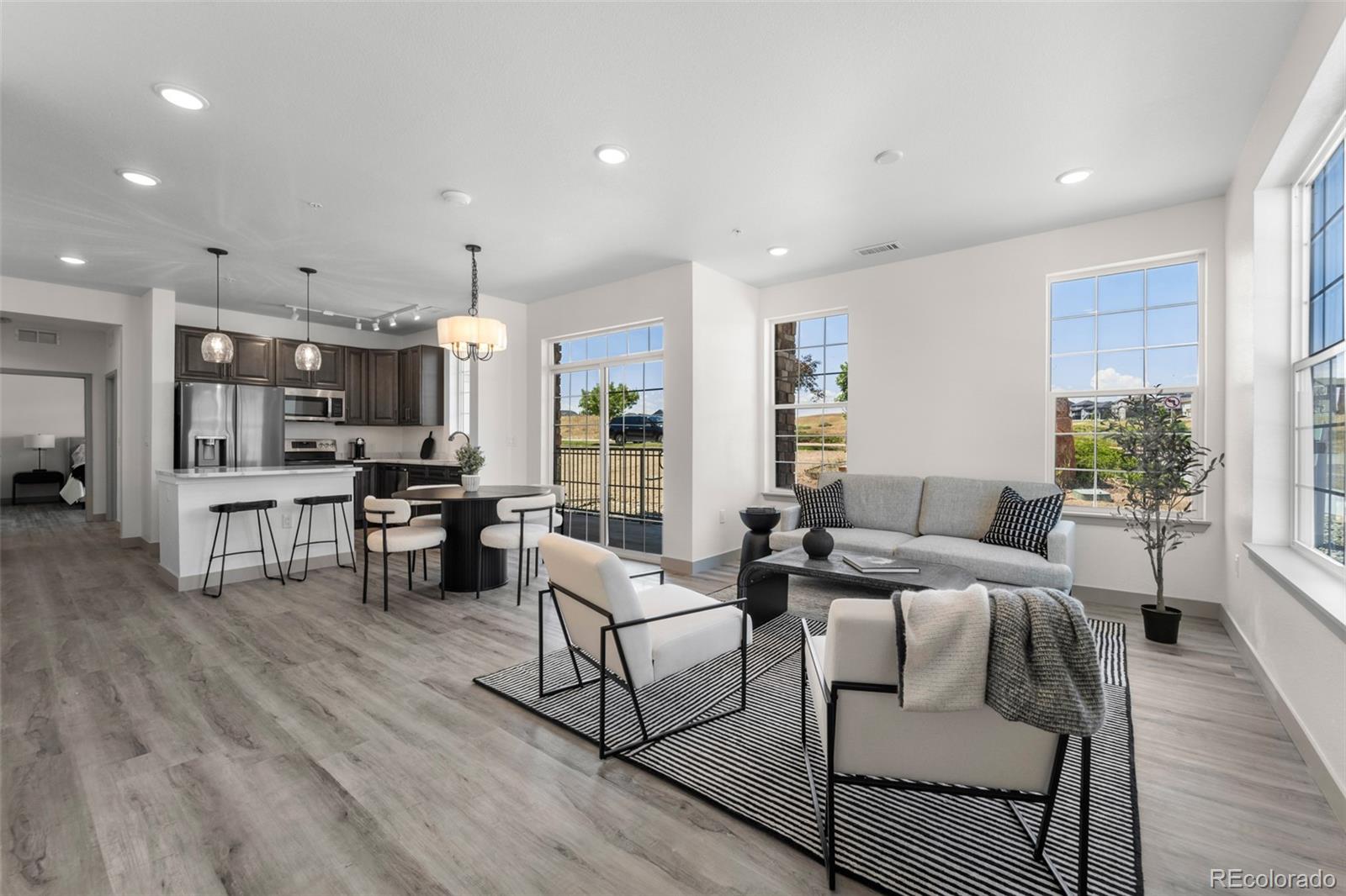 18633 Stroh Road, Unit 1102 Parker, CO 80134 - Photo 6 of 36 a living room with furniture and a wooden floor