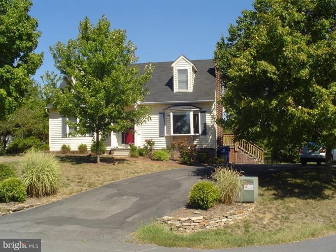 a front view of a house with a yard garage and outdoor seating