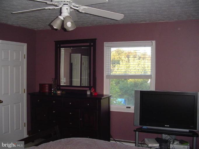 223 Killdeer Road Stephens City, VA 22655 - Photo 13 of 15 a living room with furniture and a flat screen tv