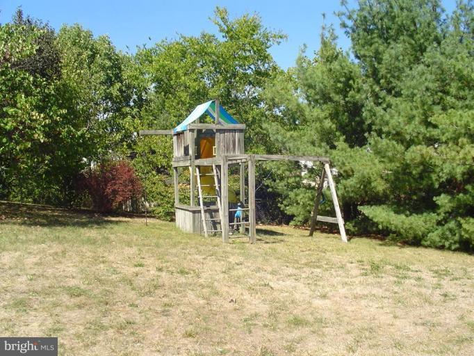 223 Killdeer Road Stephens City, VA 22655 - Photo 5 of 15 a view of a wooden house with a yard