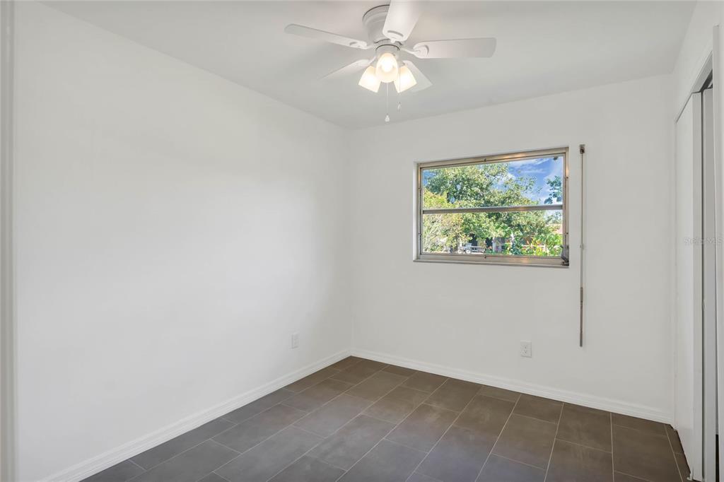 448 Ridge Drive Sanford, FL 32773 - Photo 13 of 20 an empty room with a window and a fan