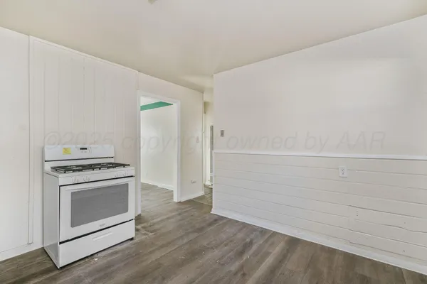 a view of a stove top oven and cabinets