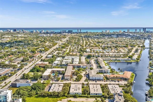 an aerial view of residential building and ocean