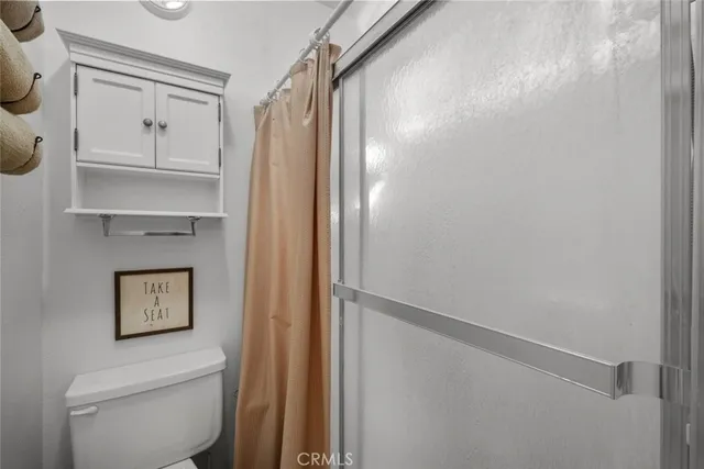 a bathroom with a shower toilet and sink