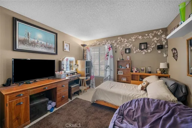 a bedroom with furniture and a flat screen tv