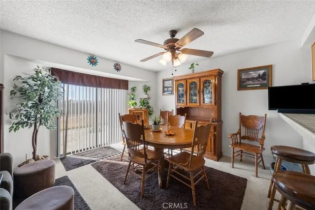a view of a a dining room with furniture window and wooden floor