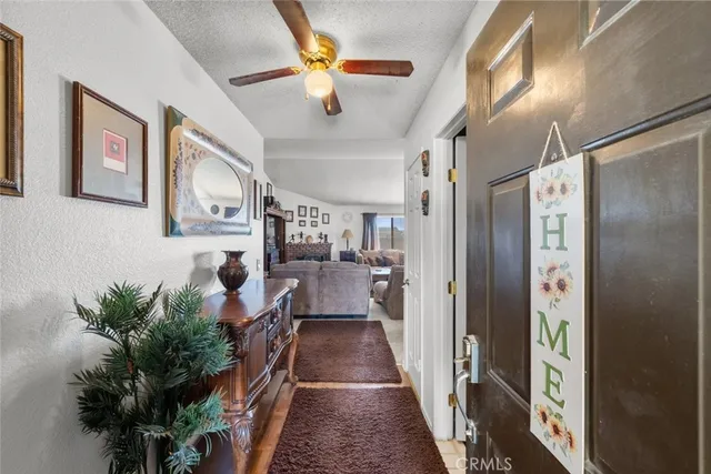 a hall way with furniture and a chandelier