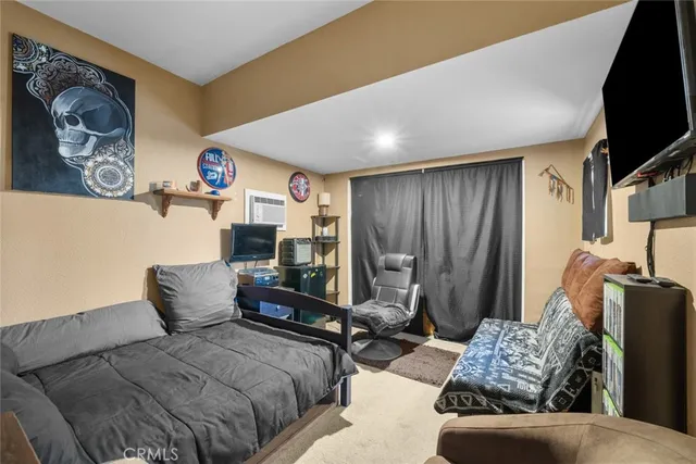 a bedroom with furniture and a flat screen tv