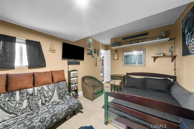 a bedroom with furniture and a flat screen tv