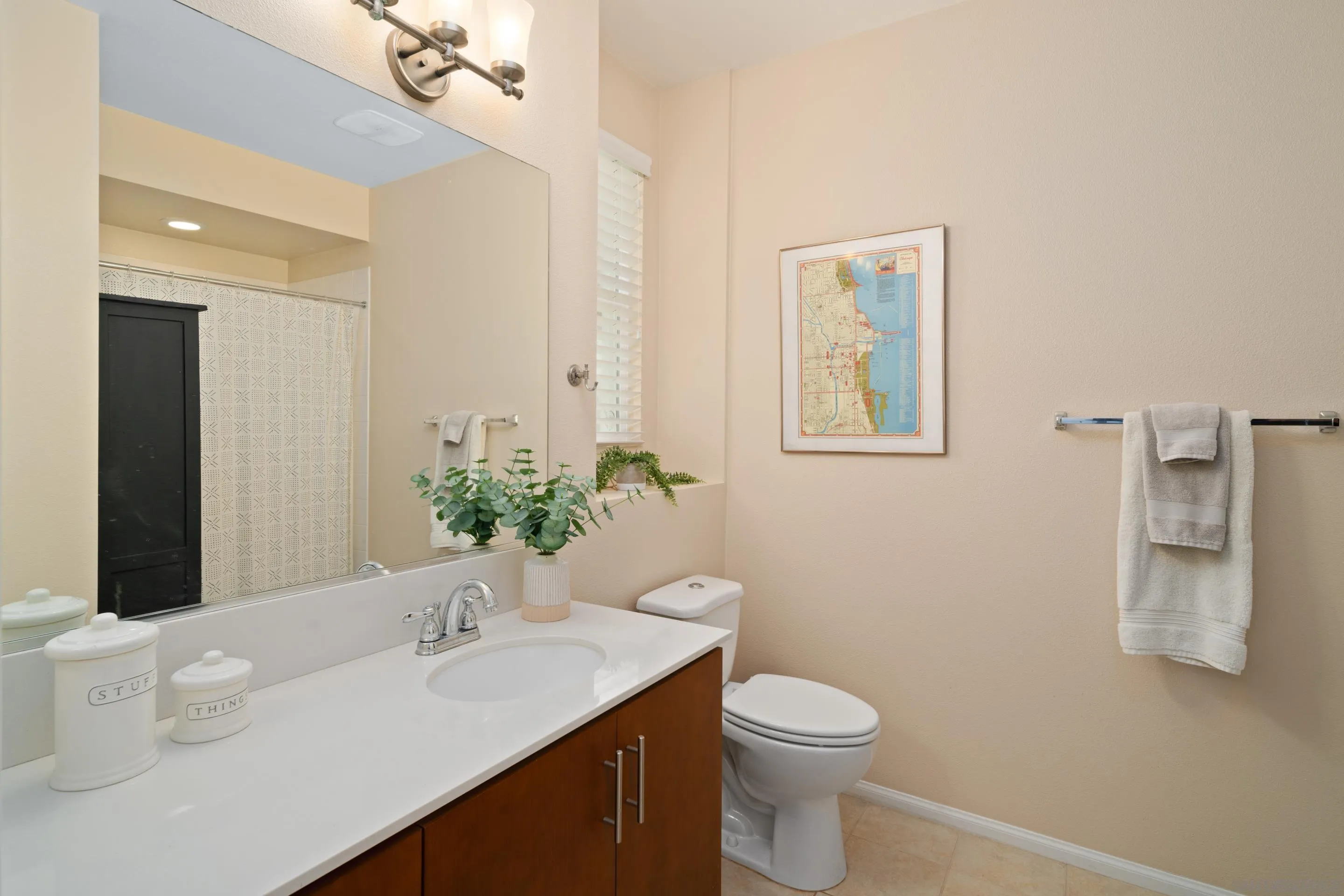 1879 Black Mustard Lane Carlsbad, CA 92011 - Photo 18 of 24 a bathroom with a toilet a sink and mirror