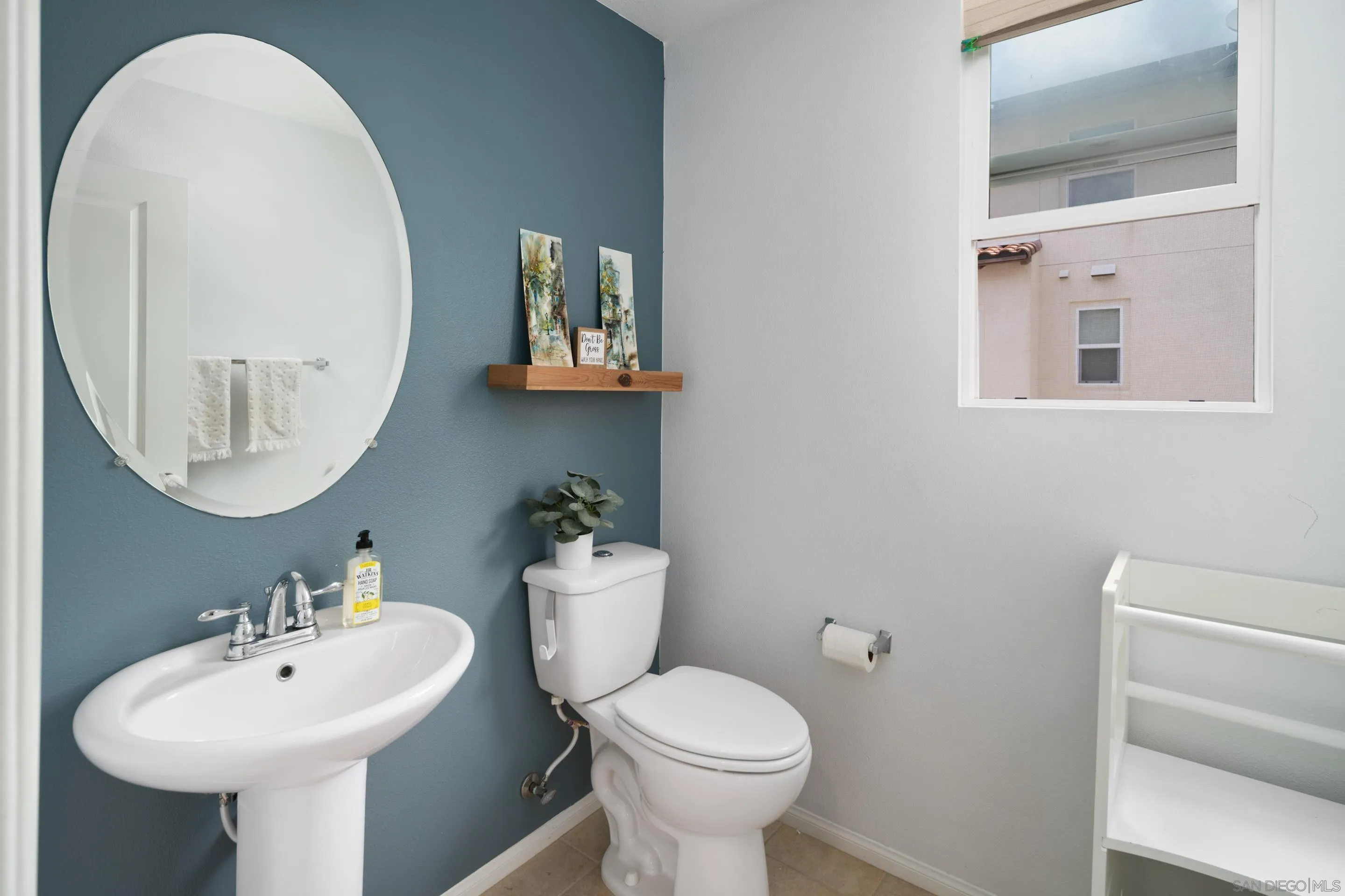 1879 Black Mustard Lane Carlsbad, CA 92011 - Photo 7 of 24 a bathroom with a toilet sink and mirror