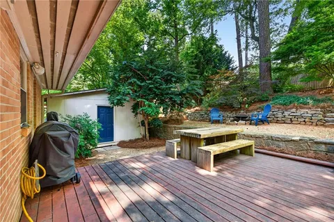 a view of a chairs setting in the backyard of a house