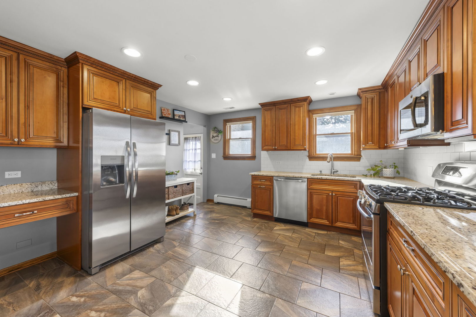 521 Lindley Road Westmont, IL 60559 - Photo 11 of 30 a large kitchen with stainless steel appliances granite countertop a stove a sink dishwasher a refrigerator and a microwave