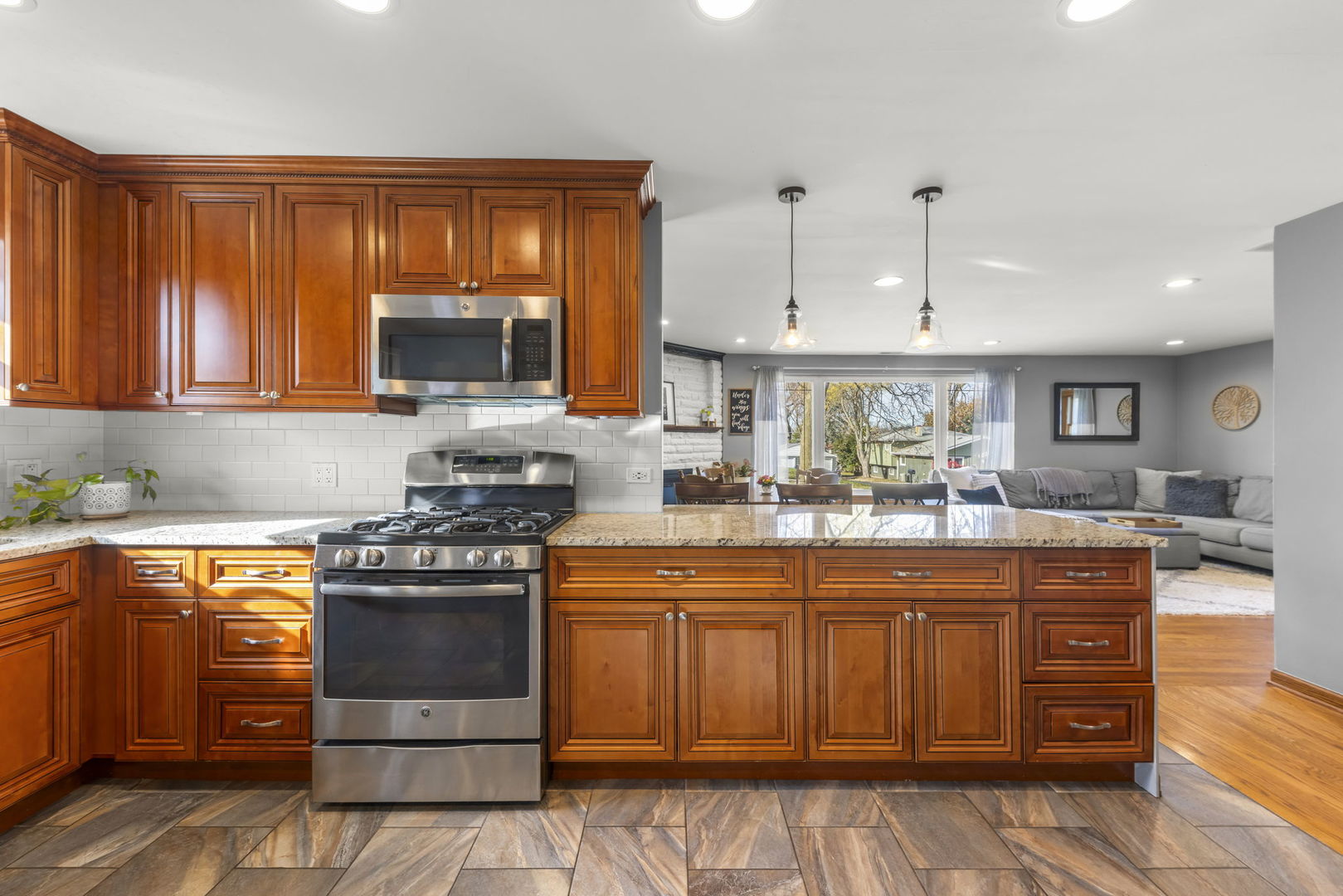 521 Lindley Road Westmont, IL 60559 - Photo 13 of 30 a kitchen with stainless steel appliances granite countertop a stove a sink and a microwave