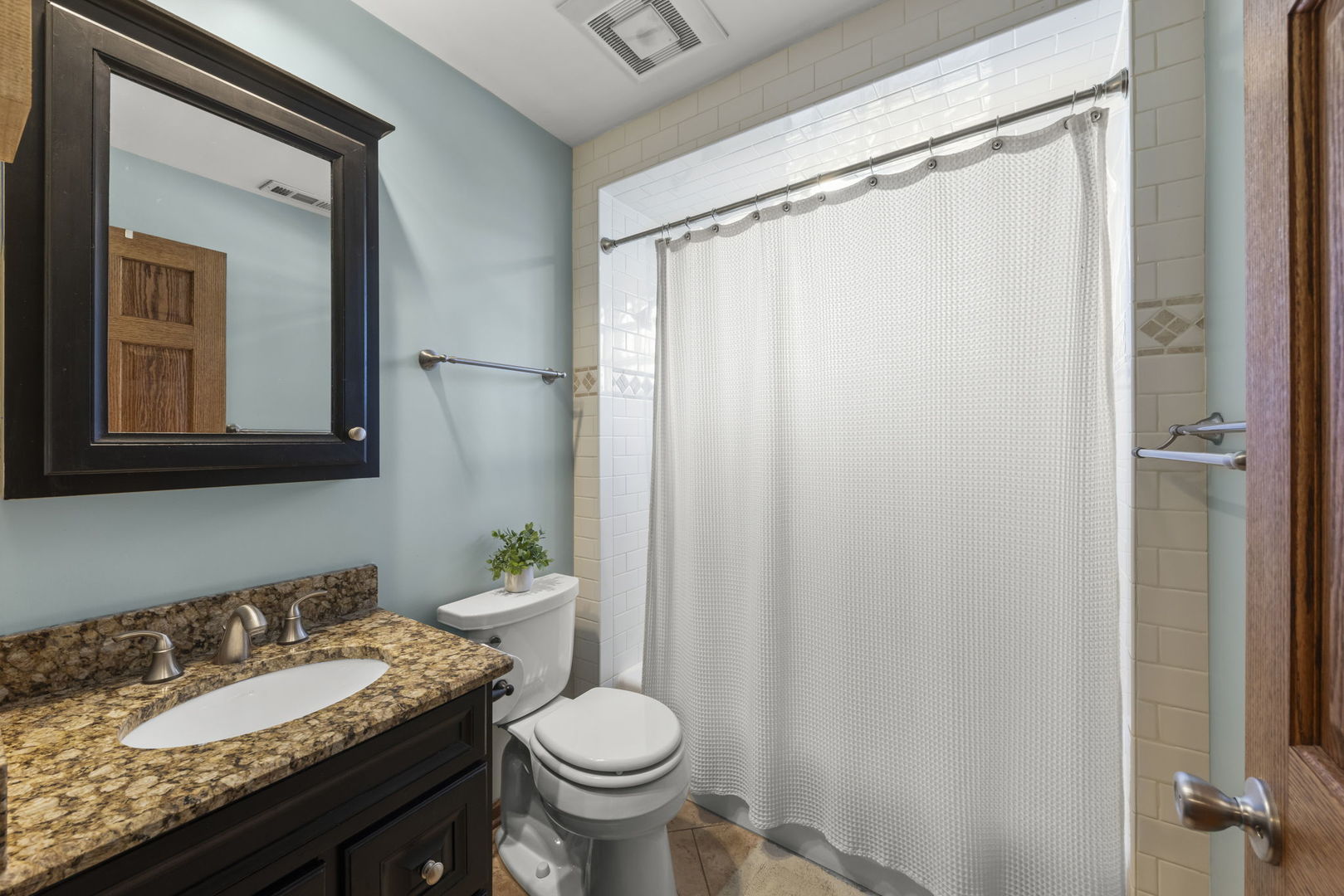 521 Lindley Road Westmont, IL 60559 - Photo 18 of 30 a bathroom with a granite countertop sink toilet and mirror