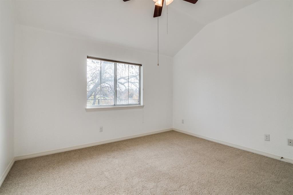 8810 Edgelake Trail Rowlett, TX 75088 - Photo 11 of 20 Spare room with vaulted ceiling, carpet floors, ceiling fan, and baseboards