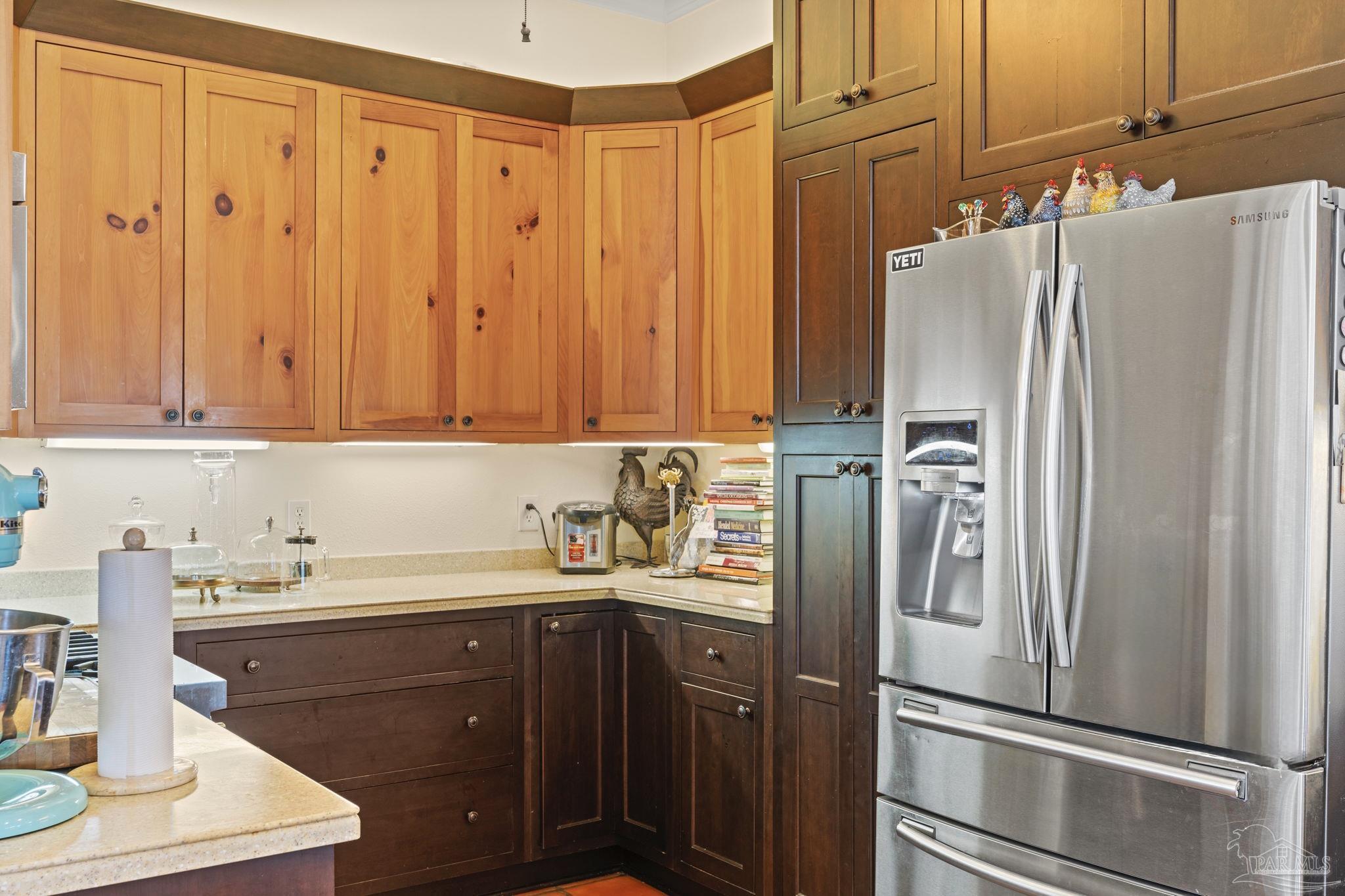 5460 North Shore Road Pensacola, FL 32507 - Photo 12 of 49 a kitchen with stainless steel appliances a refrigerator and cabinets