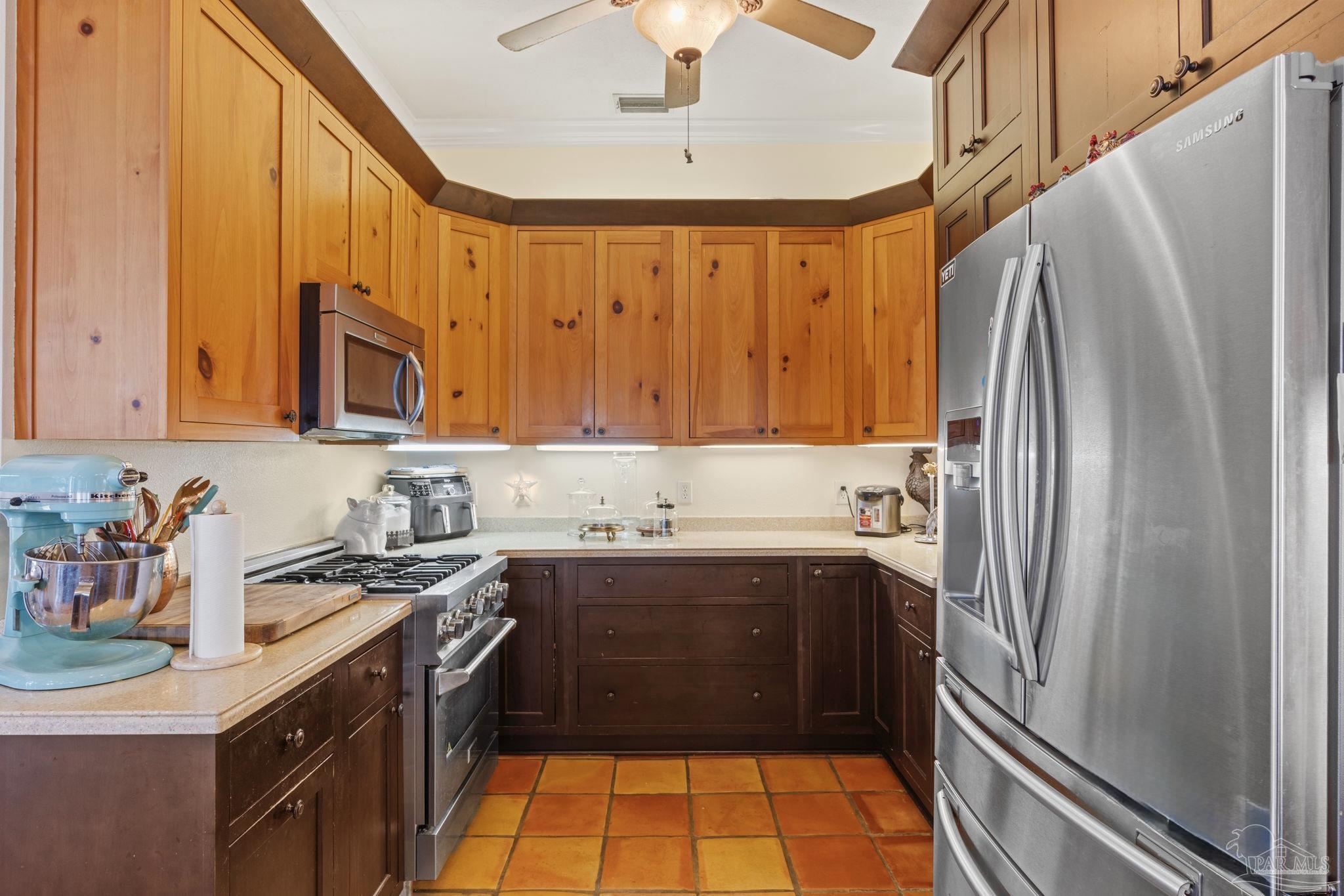 5460 North Shore Road Pensacola, FL 32507 - Photo 13 of 49 a kitchen with stainless steel appliances a sink stove and a refrigerator