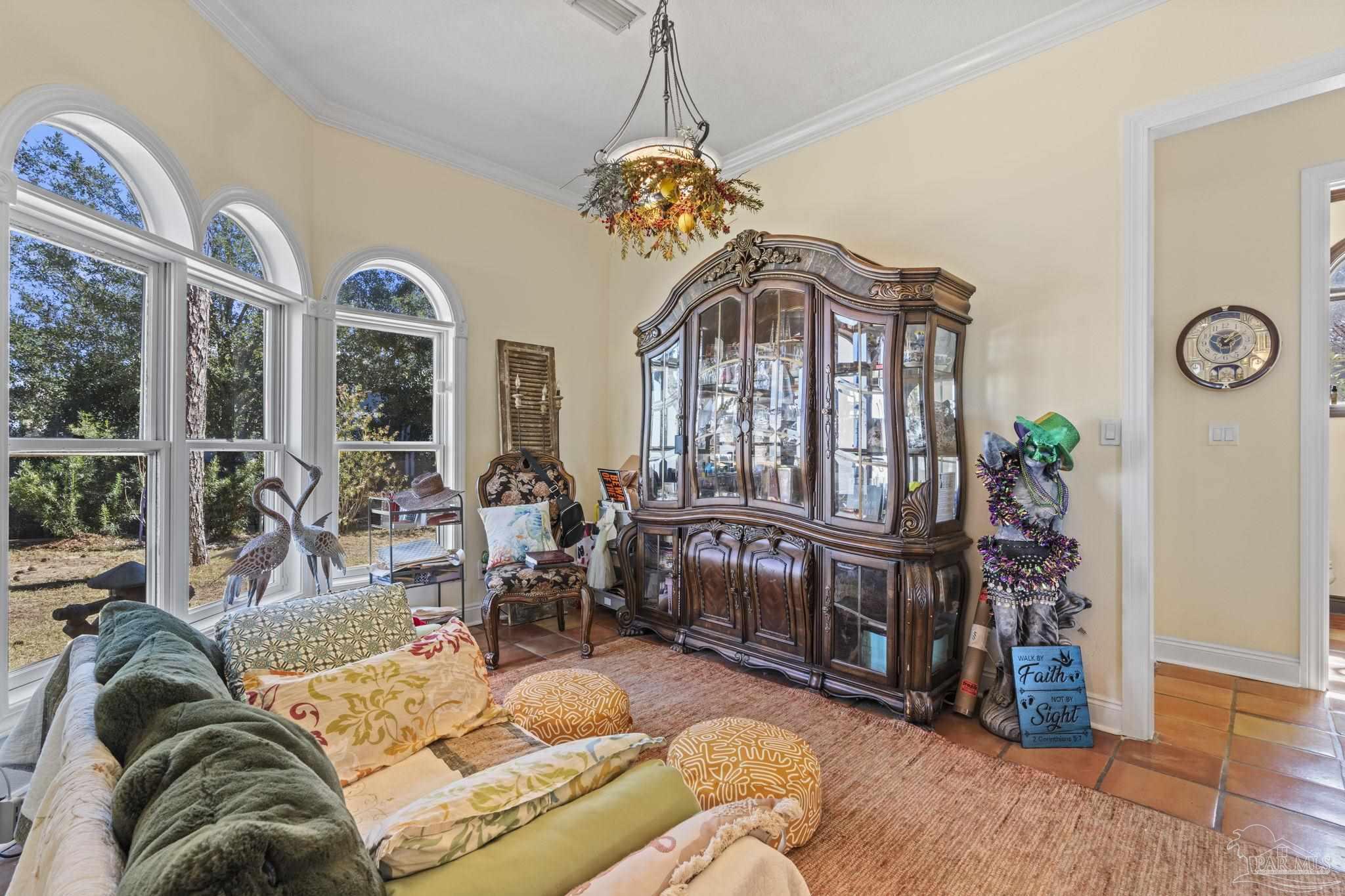 5460 North Shore Road Pensacola, FL 32507 - Photo 16 of 49 a living room with furniture a chandelier and a large window