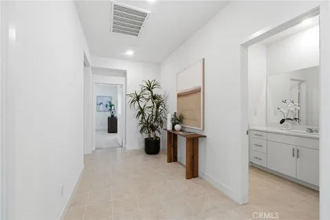 a view of a hallway and a livingroom with furniture