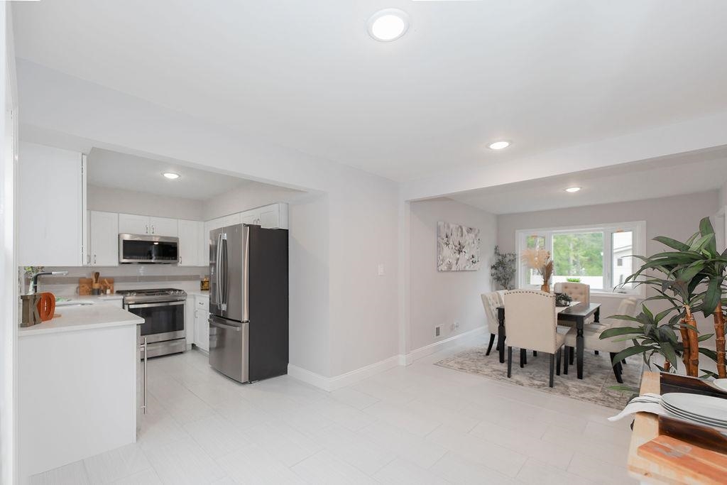 1072 Sayre Road South Union, NJ 07083 - Photo 11 of 31 a kitchen with refrigerator and chairs