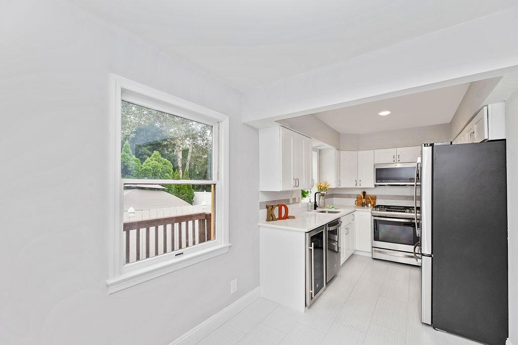 1072 Sayre Road South Union, NJ 07083 - Photo 12 of 31 a kitchen with a refrigerator and white cabinets