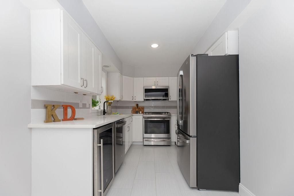 1072 Sayre Road South Union, NJ 07083 - Photo 13 of 31 a kitchen with cabinets and stainless steel appliances