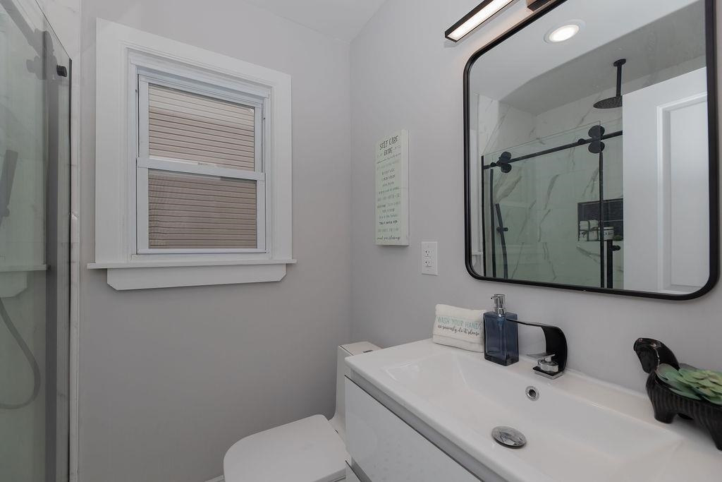 1072 Sayre Road South Union, NJ 07083 - Photo 14 of 31 a bathroom with a toilet sink and mirror