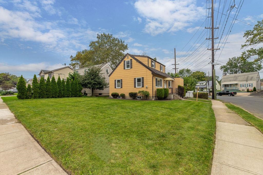 1072 Sayre Road South Union, NJ 07083 - Photo 2 of 31 a view of a white house with a big yard plants and large trees