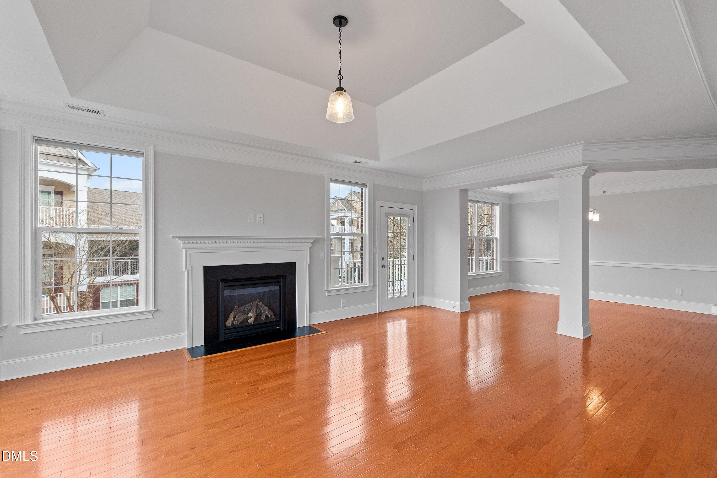 9211 Calabria Drive, Unit 205 Raleigh, NC 27617 - Photo 15 of 55 a view of an empty room with wooden floor fireplace and a window