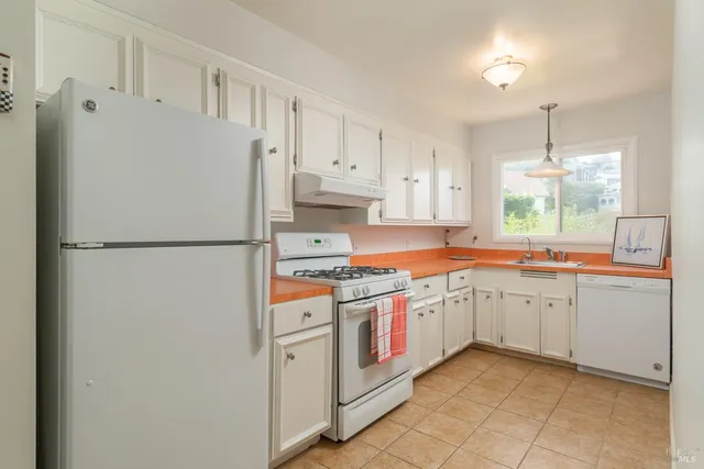 a kitchen with stainless steel appliances granite countertop a stove and a refrigerator