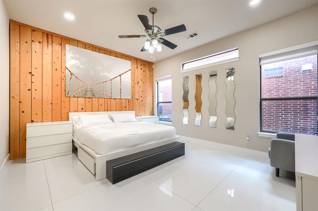 2246 Longview Road Irving, TX 75063 - Photo 19 of 40 Spacious room featuring a prominent wood panel accent wall with a unique visual texture