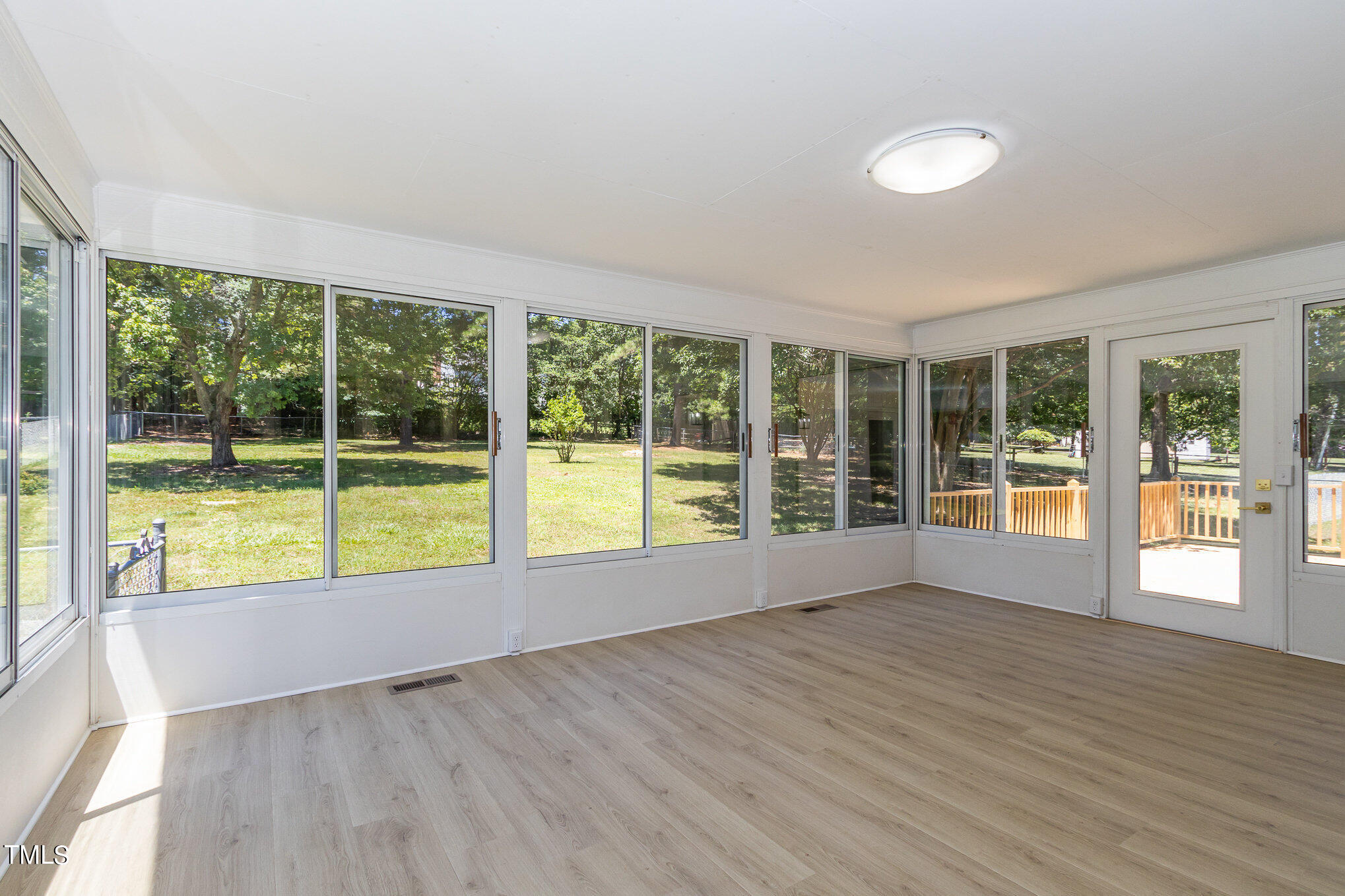 2008 Umstead Road Durham, NC 27712 - Photo 11 of 34 a view of an empty room with wooden floor and a window